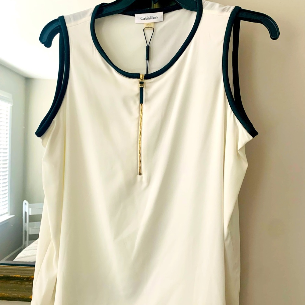 White sleeveless Calvin Klein blouse lined with black leather material. New.